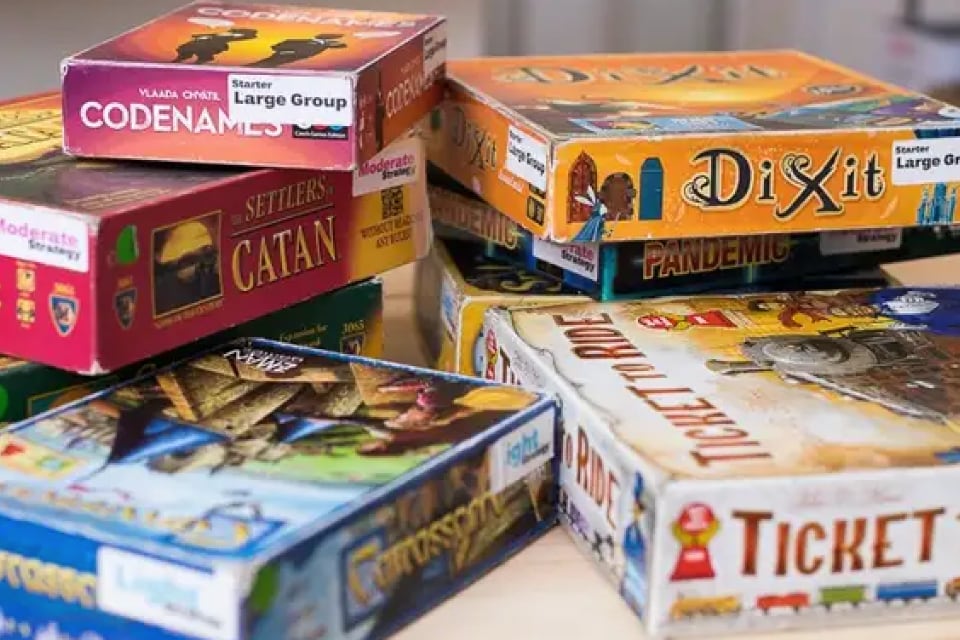 several stacked boxes of board games